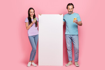 Sticker - Full length portrait of two partners use telephone chatting blogging empty space ui menu isolated on pink color background