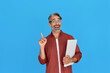 © insta_photos - Excited middle aged business man pointing finger holding laptop presenting online product service promo, advertising elearning course sale offer, having new business idea isolated on blue background.