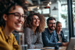 © Sitthikorn - Group of colleagues engaging in a discussion during a business meeting in a conference room. Happy business people, men and women