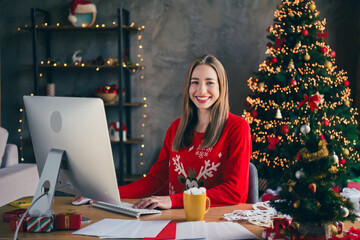 Canvas Print - Photo of attractive young woman working computer dressed christmas outfit cozy day light home party decoration interior living room