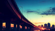 © Kraiwit - The silhouette of an overpass against a twilight sky, with city lights twinkling