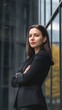 © Felippe Lopes - Confident businesswoman in a black suit standing in front of a modern building.