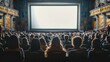 © Александр Лобач - A crowd of spectators in the dark watching a white screen in a movie theater . Spectators watching a movie in a theater