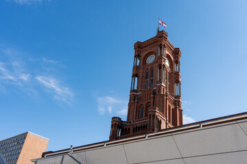 Tall red clock tower. Red City Hall of Berlin The sky is blue and there are no clouds.