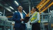 © Glce - The boss and the worker are in the factory, the boss is showing something on the tablet and they are both smiling.