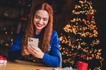 Wall Mural - Photo of lovely cheerful girl hold gadget dressed blue christmas garment tradition atmosphere decor vibe house indoors room