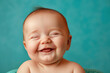 © Babb - A baby is smiling and laughing, with its mouth wide open