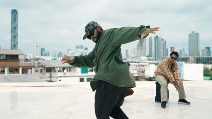 Wall Mural - Professional break dance team practice B-boy dance while multicultural friends at rooftop. Young modern dancing group doing hip hop movement. Style,fashion,action. Outdoor sport 2024. Hiphop.