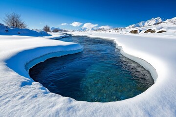 Winter nature landscape where a river flows gently through the snow, creating a beautiful contrast between ice and water