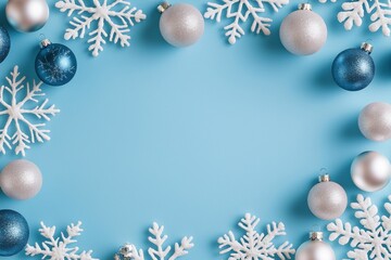 Wall Mural - elegant winter decoration featuring blue and silver ornaments with white snowflakes on a soft blue b
