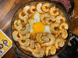 Sizzling Shrimp and Egg Dish in Hot Iron Pan at Asian Restaurant