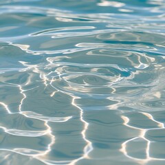 Wall Mural - Close-up view of a water surface, showcasing a clear and rippling texture. The water appears to be shallow, with light reflections creating intricate patterns on the surface