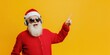 © David Zarzosa - Santa Claus in sunglasses and headphones points upwards on yellow background with copy space, for christmas and holidays advertising.