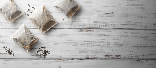 Wall Mural - Tea bags on a white wooden table Seen from above. Copy space image. Place for adding text and design