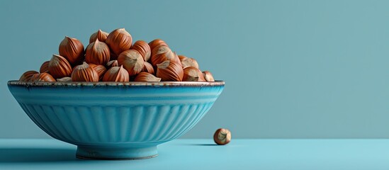 Sticker - hazelnuts in a blue dish. Copy space image. Place for adding text and design