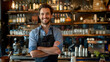 © OLHA - A man standing behind a bar with his arms crossed