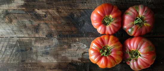 Canvas Print - Raw ripe pink heirloom organic tomatoes on a wooden surface Vegetarian Vegan healthy diet culinary cooking idea Top View. Copy space image. Place for adding text and design