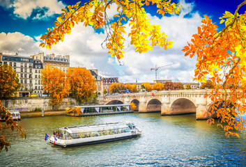 Wall Mural - pont neuf and river seine waters with cruise ship, blue sky with clouds, paris at autumn, france,