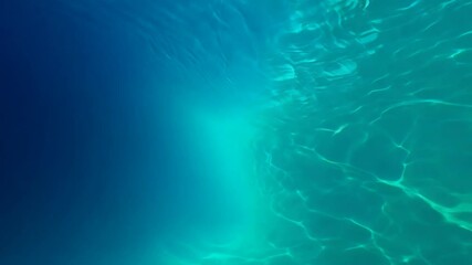 Poster - Sunlight filters through turquoise ocean water, creating a bright and vibrant underwater scene