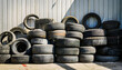 © hardvicore - Pile of used car tires in warehouse area. Industrial waste.