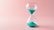 © GMeta - Vibrant turquoise sand in hourglass on pink background symbolizing creative time management