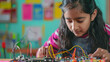© Desinage - Electronic test An Indian girl student is inventing something while tinkering with wires and connections