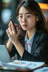 Aufkleber - A person sitting at a table looking at their smartphone