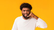 © Prostock-studio - Call me. Handsome single black man making call me sign with hand shaped like phone, orange background, copy space