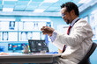 © DC Studio - General practitioner putting his medical disposable gloves on before examining a patient in cabinet, protection and prevention against bacteria. Professional medic provides healthcare services.