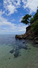 Wall Mural - footage of Blanca Beach and the blue waters of Culebra Bay, people on the sand, boats sailing, lush green trees, blue sky and clouds in Liberia Guanacaste Costa Rica