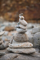 Sticker - serene beach scene with smooth rocks stacked in a balanced formation. The tranquil atmosphere evokes a sense of zen, harmony, and peace, symbolizing balance and mindfulness in nature