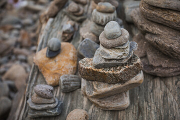 Sticker - serene beach scene with smooth rocks stacked in a balanced formation. The tranquil atmosphere evokes a sense of zen, harmony, and peace, symbolizing balance and mindfulness in nature