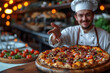 © Nataly - A chef offers fresh pizza in a restaurant. The chef smiles and looks at the camera.