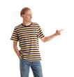 © Pixel-Shot - Handsome young man in striped t-shirt pointing at something on white background