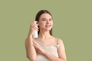 Young woman with acne problem and bottle of skincare product on green background