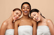 © Prostock-studio - Beauty And Spa. Three Positive Pretty Girls Wrapped In Bath Towels Posing After Shower On Gray Background In Studio
