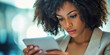 © Lila Patel - Focused Professional: A businesswoman intently studying a tablet, her expression concentrated.