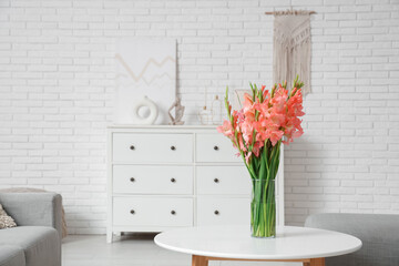 Canvas Print - Vase with gladiolus flowers on table in light living room