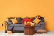 © Pixel-Shot - Interior of living room with sofa and Halloween pumpkins on table