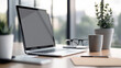 © PoodPhoto - Modern workspace featuring a laptop, glasses, and potted plant, creating a serene and productive environment.