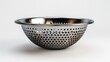© Waraporn - Perforated stainless steel concave serving bowl with a reflective metallic finish and a minimalist contemporary design  This versatile kitchen and dining accessory can be used for serving food
