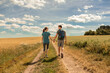 © kieferpix - Young couple walking hiking in the countryside holding hands
