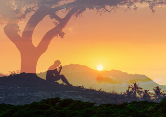 Wall Mural - Young man praying to god in the sunset 