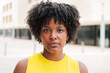 © Jose Calsina - Close up individual portrait of one serious teenage african american girl looking at camera outside. A pensive young adult woman staring front . Proud afro female gazing with thoughtfull expression