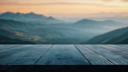 Wall Mural - A serene landscape with a wooden surface in the foreground and distant mountains at sunset.