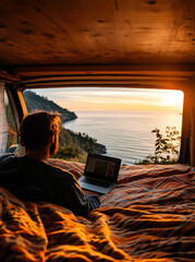 Poster - A man is sitting on a bed with a laptop open in front of him. The laptop is displaying a map of a beach. The man is looking out the window at the ocean, which is visible in the background