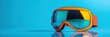 © Supriyanto - A pair of vibrant orange ski goggles with reflective lenses, designed for winter sports.