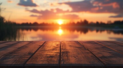 Wall Mural - A serene sunset over a calm lake, viewed from a wooden table.