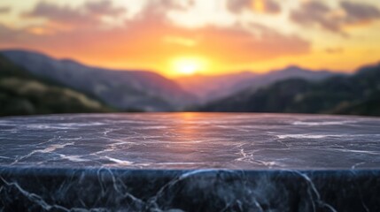 Wall Mural - A marble table in the foreground with a sunset over mountains in the background.