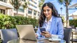 © nilawan - Businesswoman Working on Laptop and Phone in Cafe.